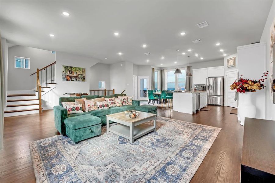 Living area featuring recessed lighting and dark wood-style flooring