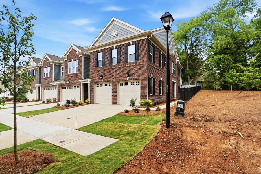 Front exterior of a new home in The Townes at Wade Ardrey, Charlotte, NC, highlighting curb appeal (Image 2). Front exterior of a new home in The Townes at Wade Ardrey, Charlotte, NC, highlighting curb appeal (Image 2).