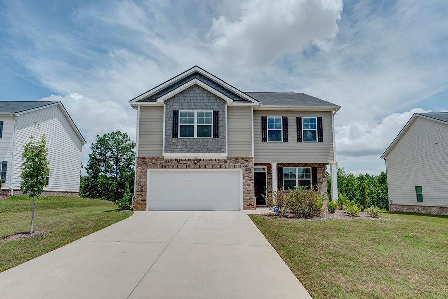 Front exterior of a new home in Cedar Ridge - Locust Grove Station, Locust Grove, GA, highlighting curb appeal (Image 2).