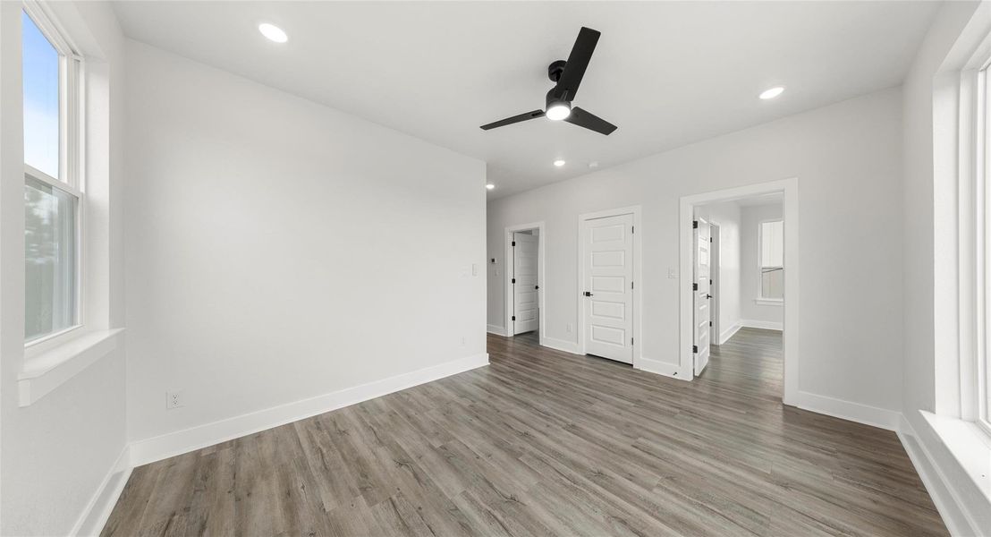 Unfurnished bedroom featuring a ceiling fan, wood finished floors, and recessed lighting