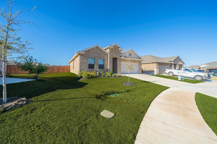 View of front of house with a front lawn and a garage