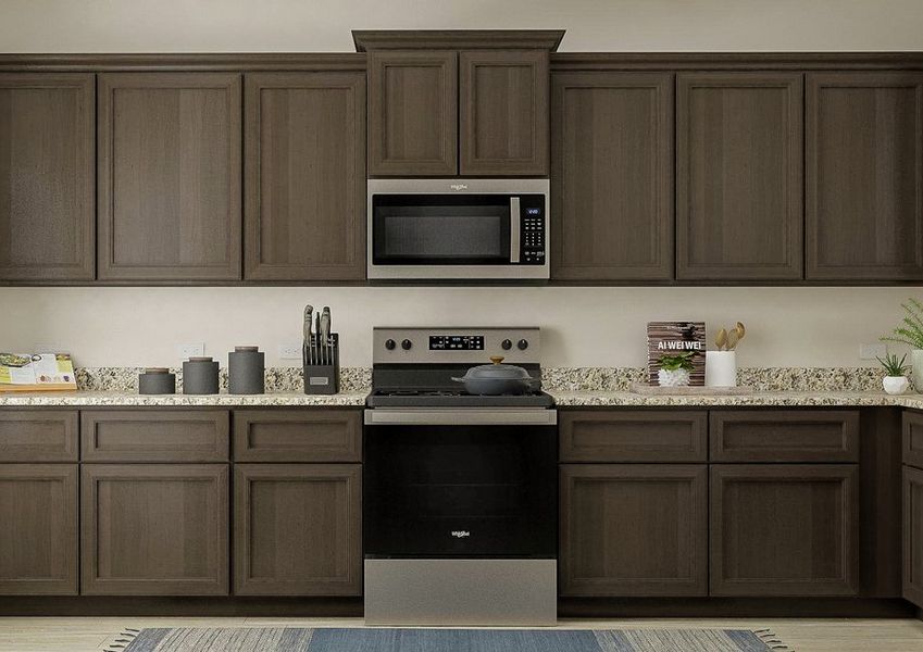 Rendering of the spacious kitchen in the
  Driftwood, which has beautiful brown cabinetry, long granite countertops and
  stainless steel appliances.