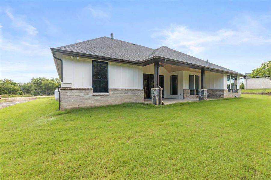 Large covered back patio with decorative lighting, fan and wood plank ceiling. Back part of patio is plumbed for gas and water. Large covered back patio with decorative lighting, fan and wood plank ceiling. Back part of patio is plumbed for gas and water.