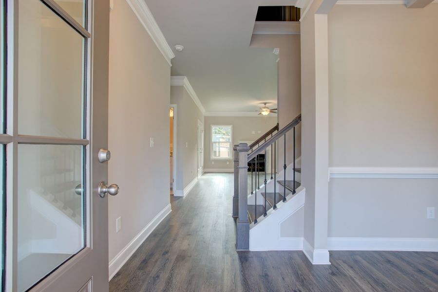 The inviting foyer opens to the staircase and the formal dining room