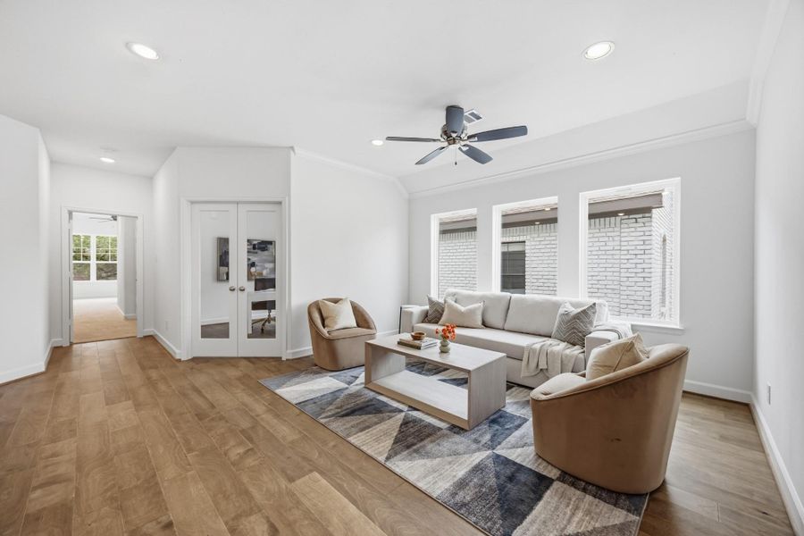 Leisure Loft: Discover a radiant game room, bathed in light, with the perfect blend of leisure and productivity just steps away in the adjacent study.