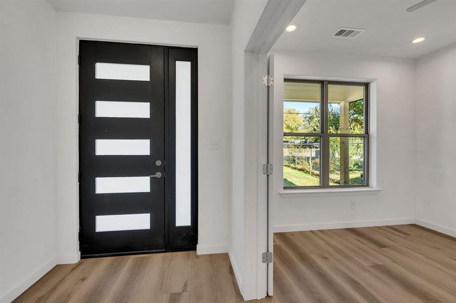 Entryway featuring light wood-style floors and recessed lighting