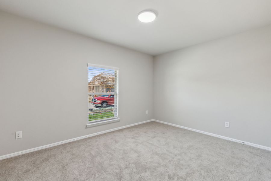 Bedroom in the Harrison home plan by Trophy Signature Homes – REPRESENTATIVE PHOTO