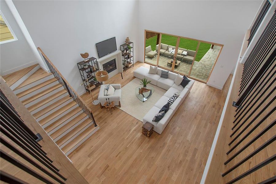 Living room featuring a high ceiling and wood-type flooring