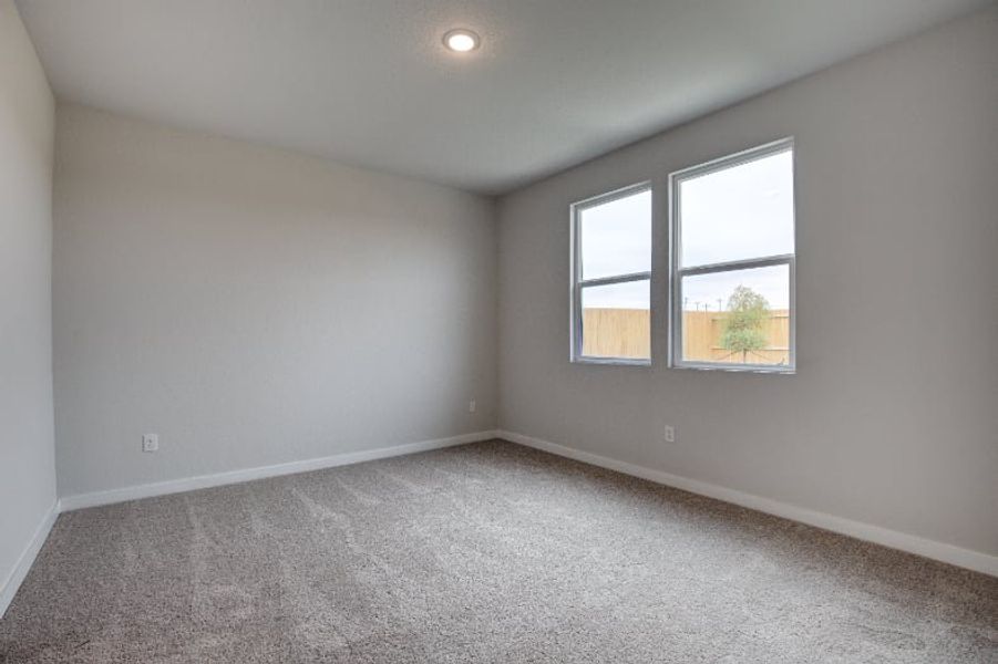 A room with a window and carpet. A room with a window and carpet.