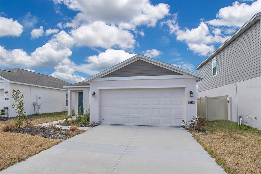Front exterior of a new home in Peace Creek Reserve, Winter Haven, FL, highlighting curb appeal (Image 2).