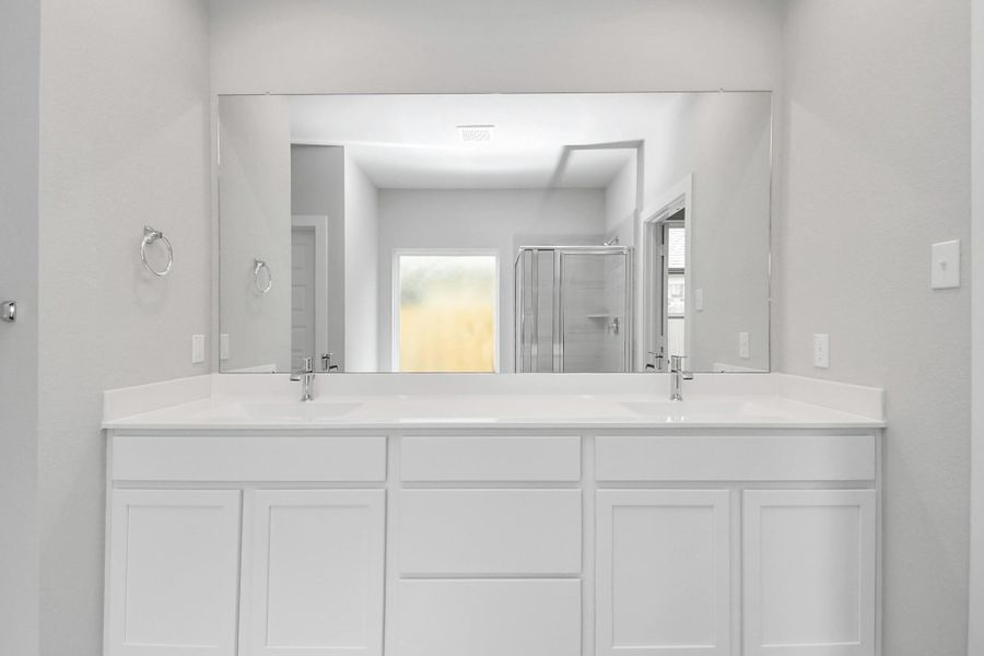 Enjoy a walk-in shower with tile surround, a separate garden tub with custom detailing, and an elegant vanity featuring light countertops, modern hardware, and bright recessed lights Enjoy a walk-in shower with tile surround, a separate garden tub with custom detailing, and an elegant vanity featuring light countertops, modern hardware, and bright recessed lights