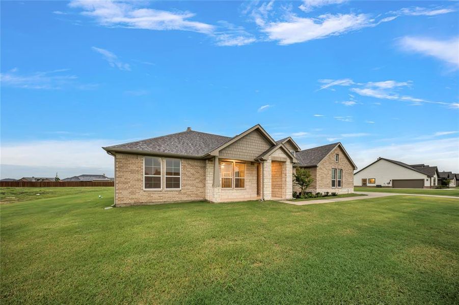 View of front of property with roof with shingles, a front lawn, and brick siding View of front of property with roof with shingles, a front lawn, and brick siding