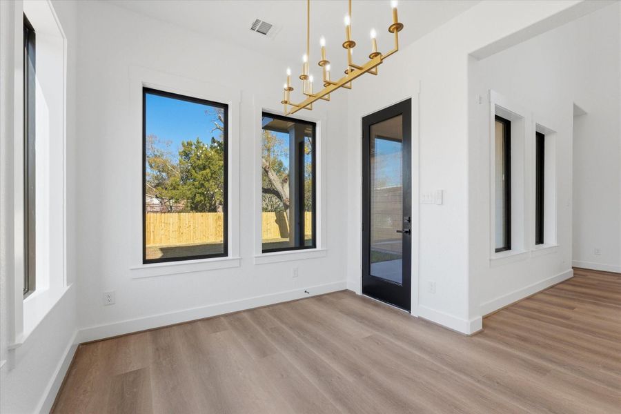 A light-filled dining area opens directly to the covered back patio, perfect for everyday meals and easy entertaining.