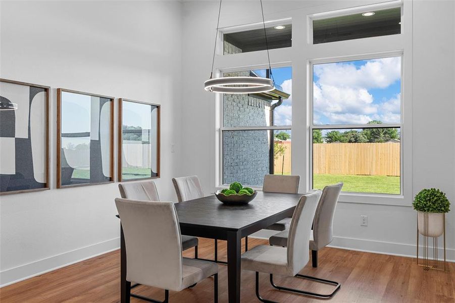 Dining area with healthy amount of natural light and wood finished floors