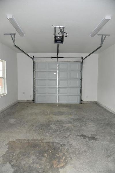 Garage featuring a garage door opener