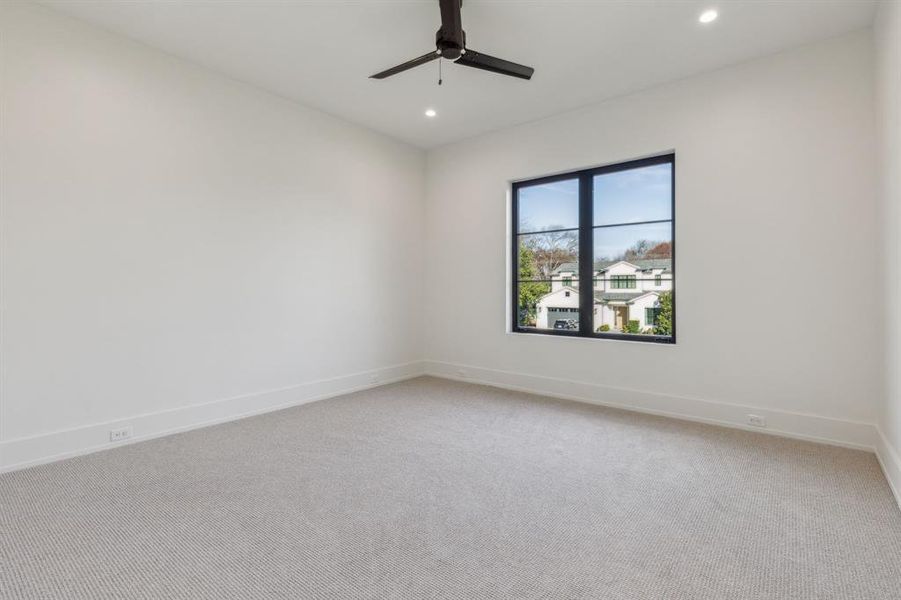 Empty room featuring ceiling fan and carpet floors