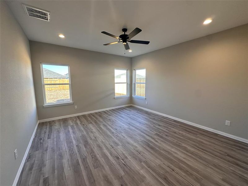 Spare room featuring hardwood / wood-style flooring and ceiling fan