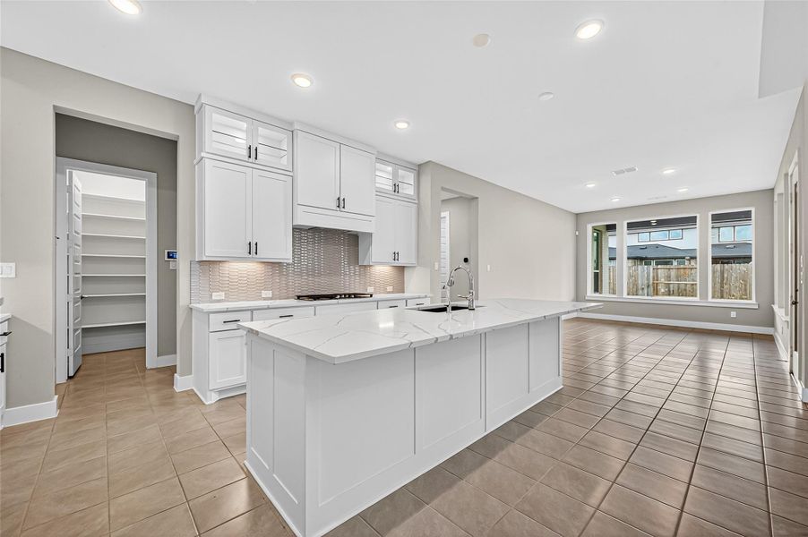 Tons of cabinet and counter space with undermount lighting and lighted display cabinets across the top of the kitchen cabinets.