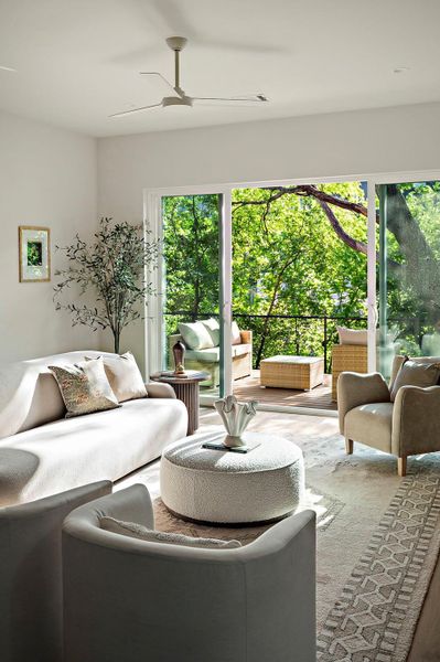 Living area featuring ceiling fan and plenty of natural light