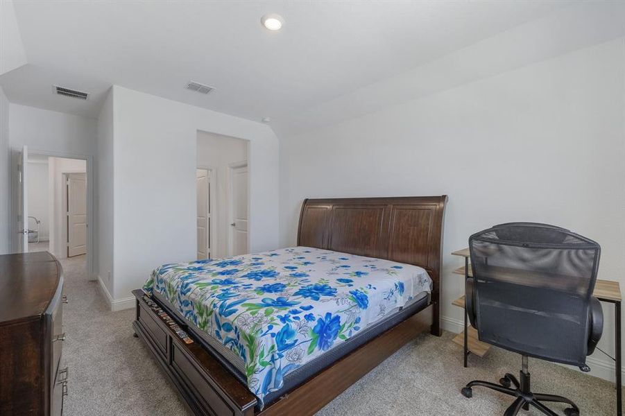 Bedroom featuring light carpet, baseboards, visible vents, and recessed lighting