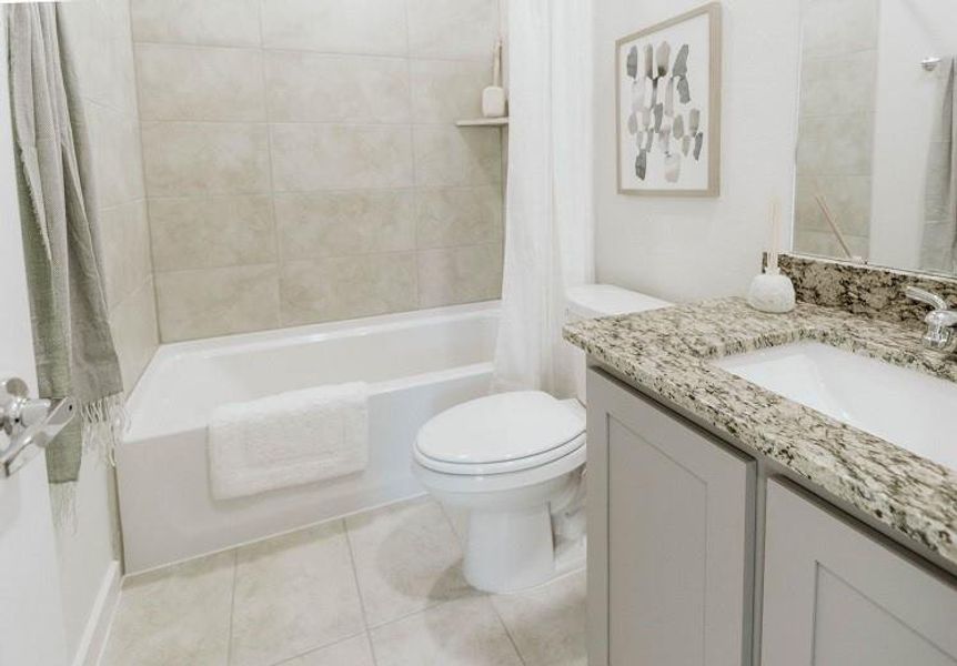 Bathroom featuring vanity, shower / tub combo with curtain, and tile patterned floors Bathroom featuring vanity, shower / tub combo with curtain, and tile patterned floors