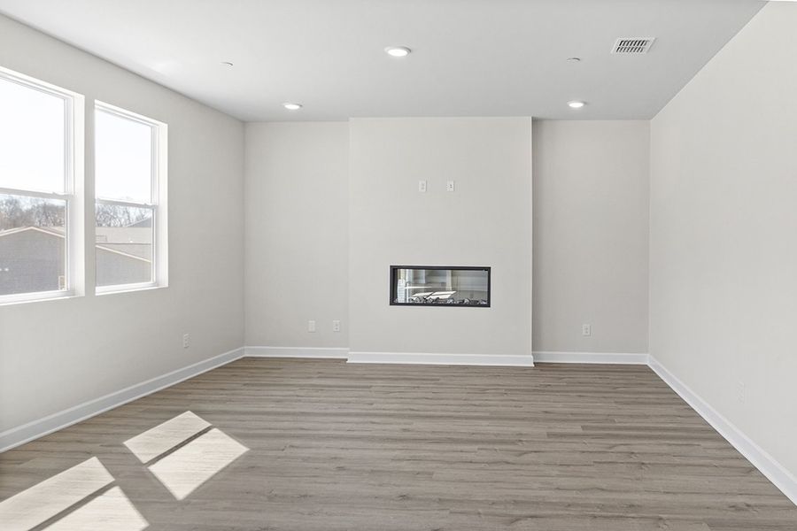 A room with a wood floor and a window with a picture on it. A room with a wood floor and a window with a picture on it.