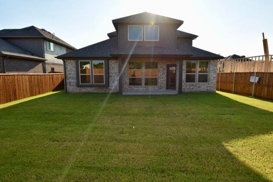 Back of property featuring brick siding, a patio, and a fenced backyard Back of property featuring brick siding, a patio, and a fenced backyard