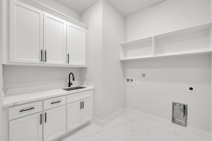 Separate utility room with countertop space and extra cabinetry for convenience Separate utility room with countertop space and extra cabinetry for convenience