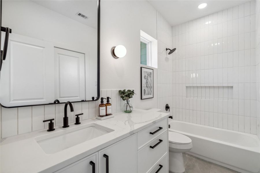 The secondary bathroom still keeps the design found throughout the home with a light and airy feel. The secondary bathroom still keeps the design found throughout the home with a light and airy feel.