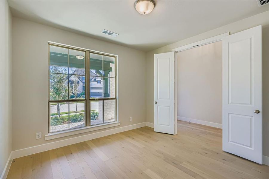Unfurnished bedroom with light wood-type flooring and baseboards