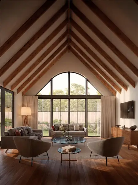 A spacious living area with soaring 15 ft vaulted ceilings at the peak, wood exposed beams, and an abundance of natural light. A spacious living area with soaring 15 ft vaulted ceilings at the peak, wood exposed beams, and an abundance of natural light.