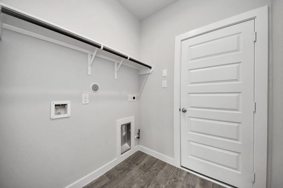 A perfect blend of functionality and comfort. Capture the essence of easy living with a first-floor laundry room, thoughtfully equipped with shelving for effortless organization. Both electric and gas connections available. A perfect blend of functionality and comfort. Capture the essence of easy living with a first-floor laundry room, thoughtfully equipped with shelving for effortless organization. Both electric and gas connections available.