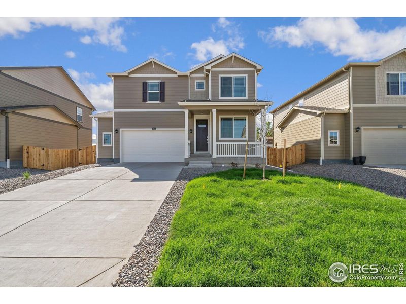 Front exterior of a new home in Brighton Crossing, Brighton, CO, highlighting curb appeal (Image 1).