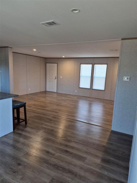 Unfurnished living room with dark wood-style floors