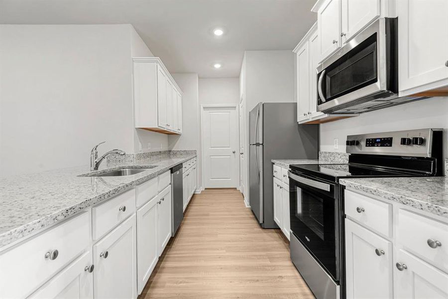 Whirlpool kitchen appliances and granite countertops make this kitchen chef-ready!