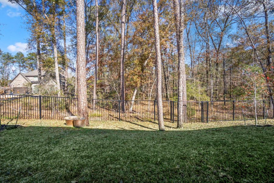Your covered patio offers a serene, wooded view, providing privacy and a natural backdrop.