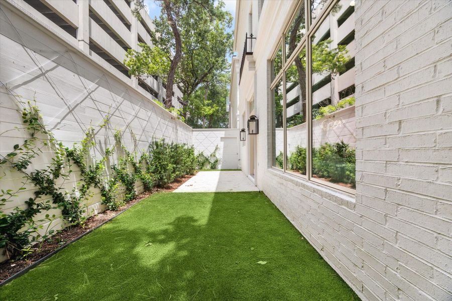 Brick pavers, turfed yard, and beautiful landscaping with custom trellis make this space just as curated and welcoming as the home's interior, to seamlessly blend indoor and outdoor living. Brick pavers, turfed yard, and beautiful landscaping with custom trellis make this space just as curated and welcoming as the home's interior, to seamlessly blend indoor and outdoor living.