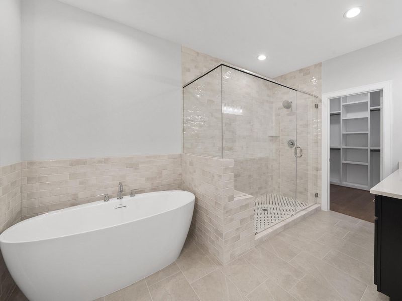 Enjoy your luxurious spa-style bath with dual vanities and an oversized walk-in shower for a true daily escape. Image depicts home as-is.