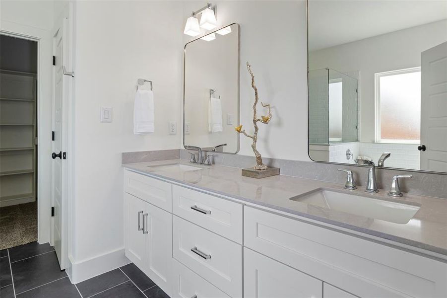 Bathroom with tile floors, double sink, and oversized vanity