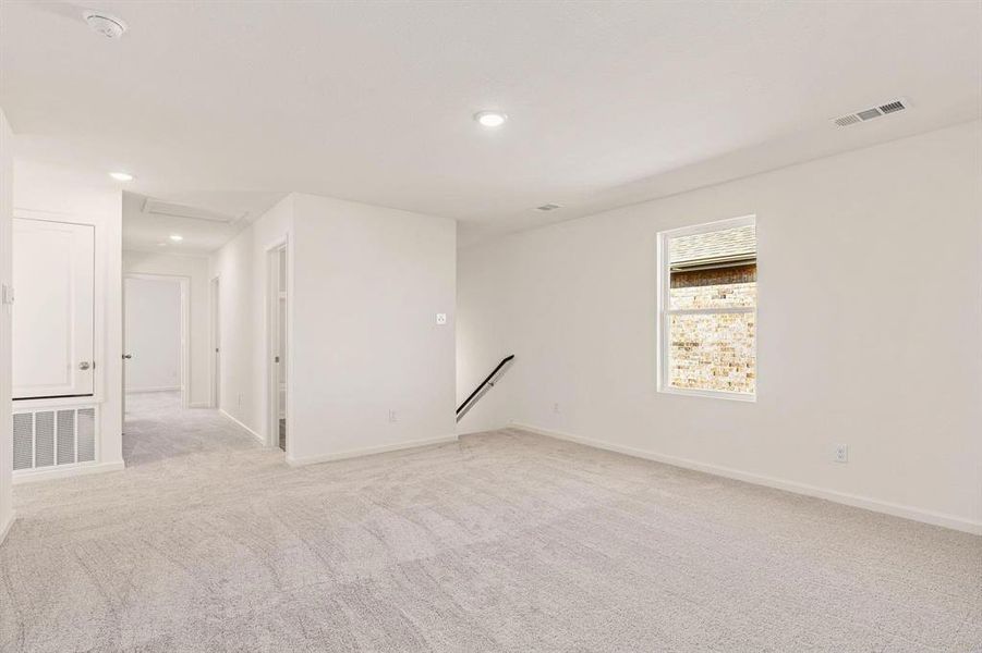 Empty room with light carpet and recessed lighting Empty room with light carpet and recessed lighting