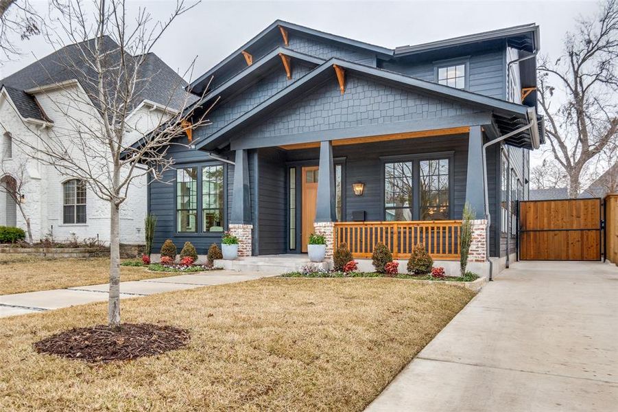 Craftsman-style house with a front yard and a porch