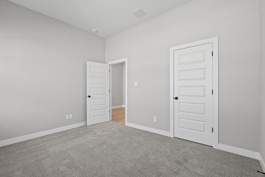 Unfurnished bedroom with carpet floors and a closet