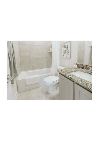 Full bathroom featuring toilet, vanity, shower / tub combo, and tile patterned flooring