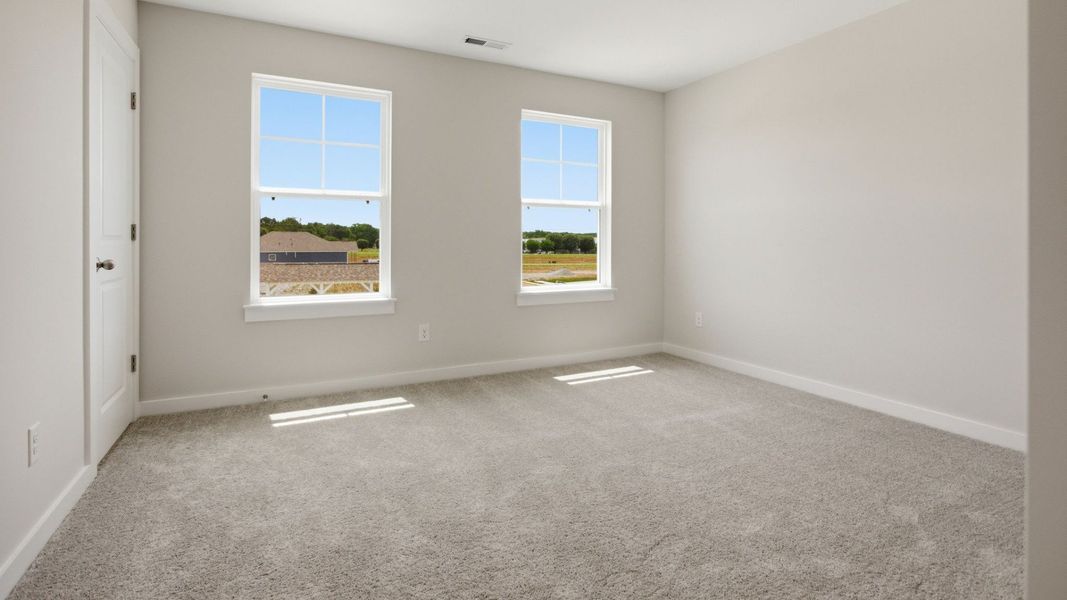 Bedroom with carpet and windows Bedroom with carpet and windows