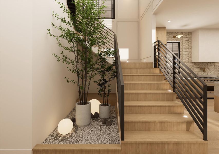 Designed as more than a passageway, this statement stairwell blends modern lines with organic serenity. Clean iron balusters rise alongside a curated pebble bed and layered greenery, creating an unexpected design feature that feels both grounded and artfully composed. Designed as more than a passageway, this statement stairwell blends modern lines with organic serenity. Clean iron balusters rise alongside a curated pebble bed and layered greenery, creating an unexpected design feature that feels both grounded and artfully composed.