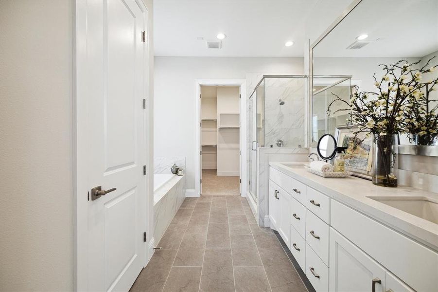 Primary bathroom retreat on the 3rd level offers a tranquil setting with a separate tub/shower.