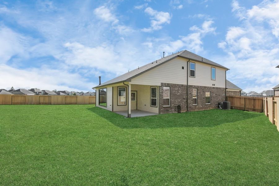 Explore the expansive backyard with its inviting covered patio—a perfect blend of space for the kids to play and adults to unwind. Ideal for creating your outdoor oasis, this backyard accommodates patio furniture, a BBQ pit, and endless possibilities for leisure and entertainment. Sample photo of completed home with similar floor plan. Actual colors and selections may vary.