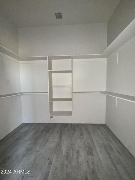 Primary bedroom walk-in closet