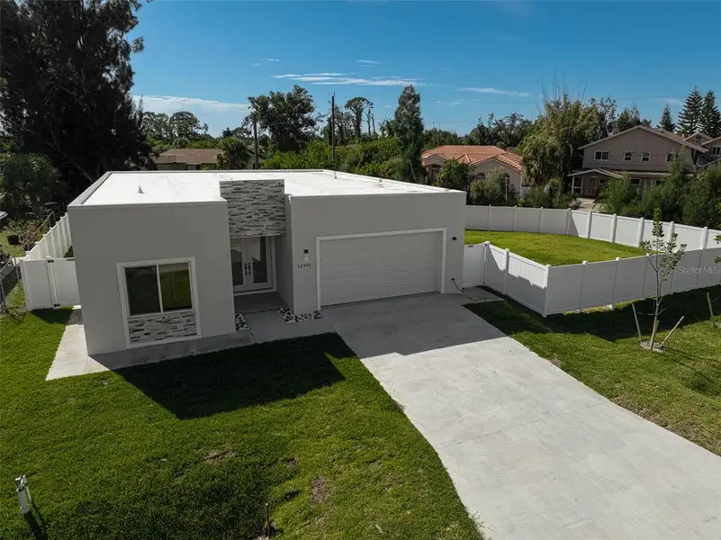 Front exterior of a new home in , North Port, FL, highlighting curb appeal (Image 1).