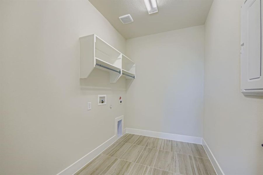 Laundry area with hookup for a washing machine, hookup for a gas dryer, hookup for an electric dryer, and electric panel Laundry area with hookup for a washing machine, hookup for a gas dryer, hookup for an electric dryer, and electric panel